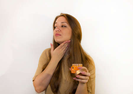 young beautiful woman uses face creamの写真素材