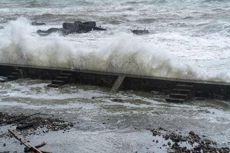 storm on the black sea, waves crashing on the shore, brown water