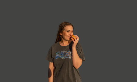 young beautiful woman with orange smiling and happy