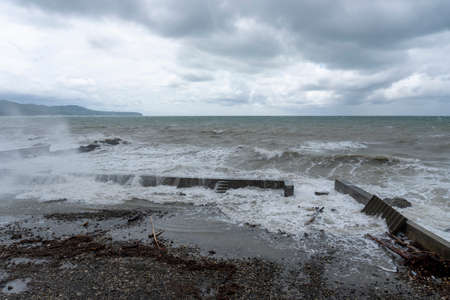 storm on the black sea, waves crashing on the shore, brown water