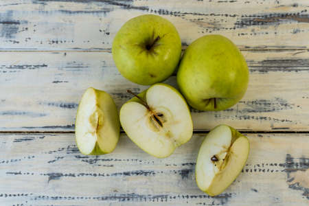 Green apples on wooden background