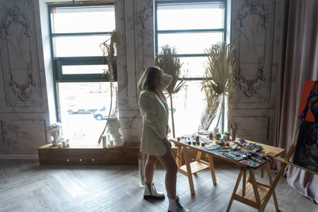 silhouette on the background of the window of a young artist, palette and paintsの写真素材