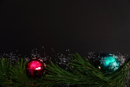 beautiful black christmas background for postcards, flyers, banners. Christmas tree branch and...