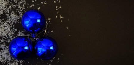beautiful black christmas background for postcards, flyers, banners. Christmas tree branch and Christmas balls and toysの写真素材
