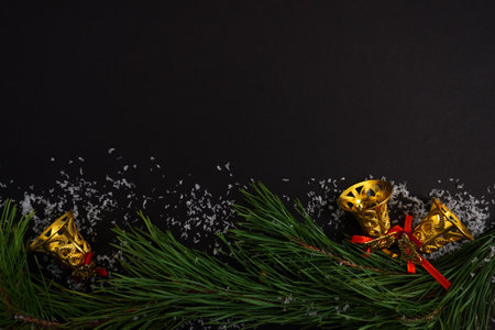 beautiful black christmas background for postcards, flyers, banners. Christmas tree branch and Christmas balls and toysの写真素材