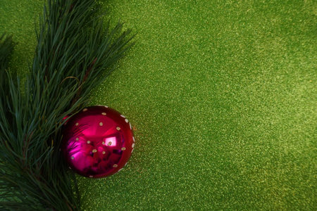 green christmas background with fir tree branch and christmas balls and toysの写真素材