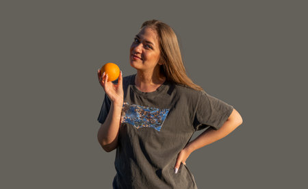 young beautiful woman with orange smiling and happyの写真素材