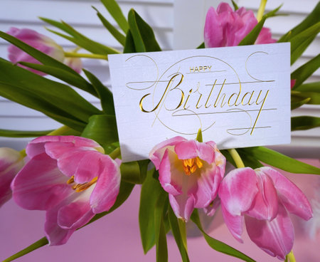 postcard , Internet banner with a birthday greeting, with the inscription - happy birthday, a bouquet of flowers with a note of congratulations, tulipsの写真素材
