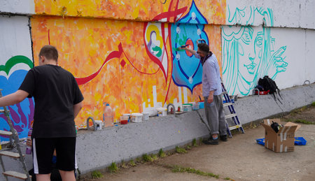Naberezhnye Chelny, Russia - May 20, 2023 : Festival of street graphics-graffiti, young people, guys and girls, draw on the walls with paintsのeditorial素材