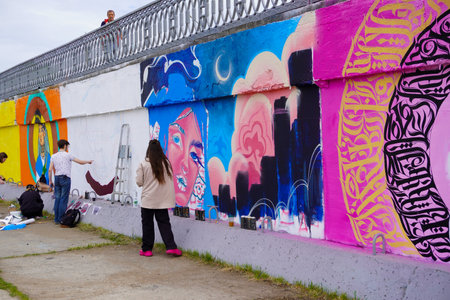 Naberezhnye Chelny, Russia - May 20, 2023 : Festival of street graphics-graffiti, young people, guys and girls, draw on the walls with paintsのeditorial素材