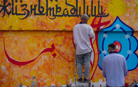 Naberezhnye Chelny, Russia - May 20, 2023 : Festival of street graphics-graffiti, young people, guys and girls, draw on the walls with paintsのeditorial素材
