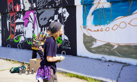 Naberezhnye Chelny, Russia - May 20, 2023 : Festival of street graphics-graffiti, young people, guys and girls, draw on the walls with paintsのeditorial素材