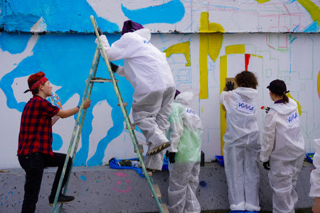 Naberezhnye Chelny, Russia - May 20, 2023 : Festival of street graphics-graffiti, young people, guys and girls, draw on the walls with paintsのeditorial素材