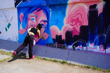 Naberezhnye Chelny, Russia - May 20, 2023 : Festival of street graphics-graffiti, young people, guys and girls, draw on the walls with paintsのeditorial素材