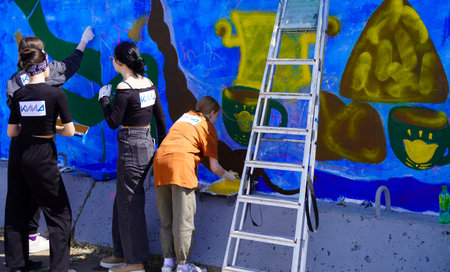 Naberezhnye Chelny, Russia - May 20, 2023 : Festival of street graphics-graffiti, young people, guys and girls, draw on the walls with paintsのeditorial素材