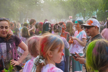 Naberezhnye Chelny, Russia - May 20, 2023 : Holi festival of colors, young people, guys and girls celebrate the beginning of spring and shower each other with colorful paintsのeditorial素材