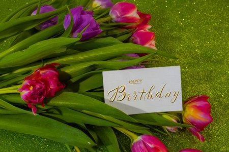 postcard , Internet banner with a birthday greeting, with the inscription - happy birthday, a bouquet of flowers with a note of congratulations, tulipsの写真素材