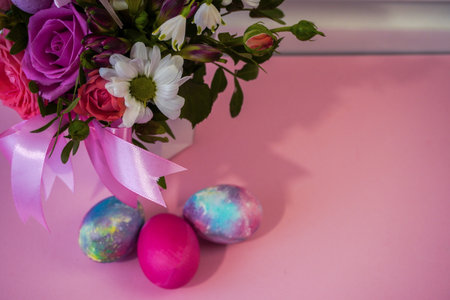 Happy Easter! Flat Lay, postcard or Internet banner with Copy Space on Easter. Bouquet of flowers and Easter eggsの写真素材
