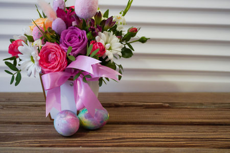 Happy Easter! Flat Lay, postcard or Internet banner with Copy Space on Easter. Bouquet of flowers and Easter eggsの写真素材