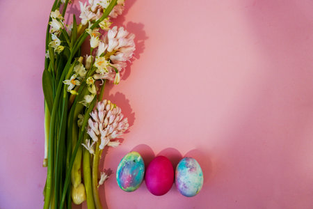 Happy Easter! Flat Lay, postcard or Internet banner with Copy Space on Easter, Bouquet of flowers and Easter eggsの写真素材