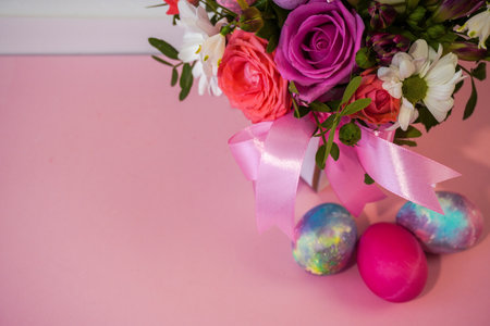 Happy Easter! Flat Lay, postcard or Internet banner with Copy Space on Easter. Bouquet of flowers and Easter eggsの写真素材