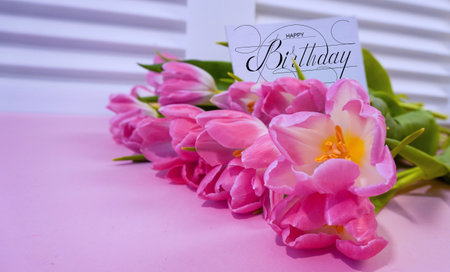postcard , Internet banner with a birthday greeting, with the inscription - happy birthday, a bouquet of flowers with a note of congratulations, tulipsの写真素材