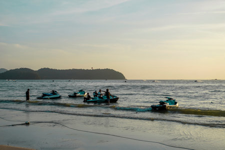 Langkawi, Malaysia - January 29, 2024 : Langkawi island in Malaysia, Chenang beach in the evening, people walk along the beachのeditorial素材
