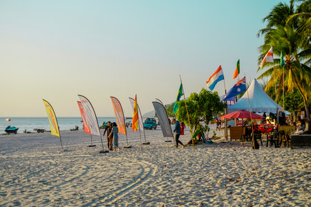Langkawi, Malaysia - January 29, 2024 : Langkawi island in Malaysia, Chenang beach in the evening, people walk along the beachのeditorial素材