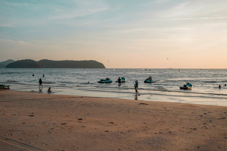 Langkawi, Malaysia - January 29, 2024 : Langkawi island in Malaysia, Chenang beach in the evening, people walk along the beachのeditorial素材