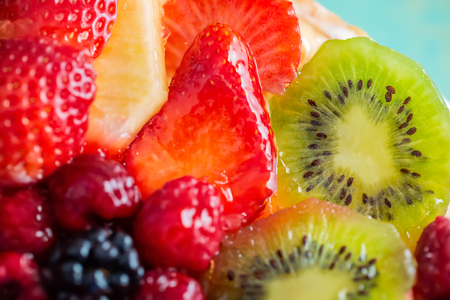 Slice kiwi and a variety of fresh fruits in sweet gelatin. Berries close-up in soft focus. Delicious dessert. Beautiful background of fruit. Food. Top view. Macro.の写真素材