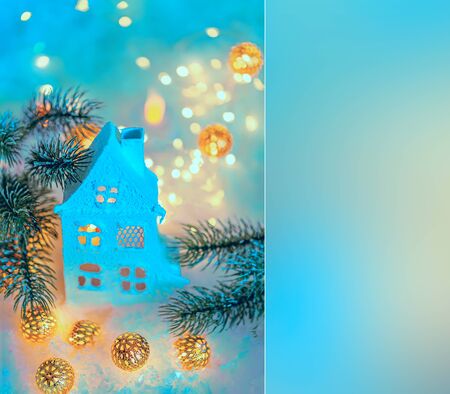 Blue cottage or chalet. Greeting card Happy New Year and Merry Christmas. Beautiful background for the holiday. Toned image. Soft focus. Mockup. Top view. Copy space. Art photography.の写真素材