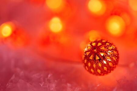 Garland of metallic luminous balls on the snow. Greeting card Happy New Year and Merry Christmas. Beautiful  blurred background. Shallow depth of field. Toned image. Copy spaceの写真素材
