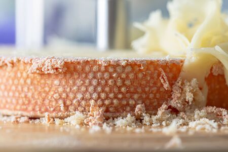Macro of cheese Monk Head. Cheese with girolle knife and crumbs. Shallow depth of field. Copy space....