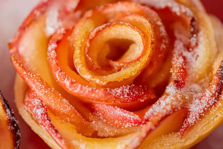 Pieces of apples baked and sprinkled with sugar. Flower with apples. Top view. Macro