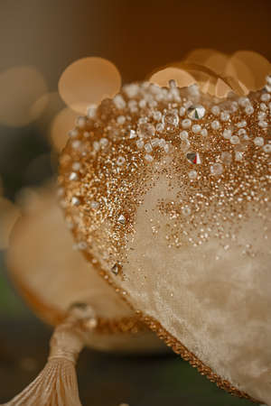 Close-up of half a velvet heart with beads. Valentines Day. Dark blurred background with bokeh. Wedding greeting card.の写真素材