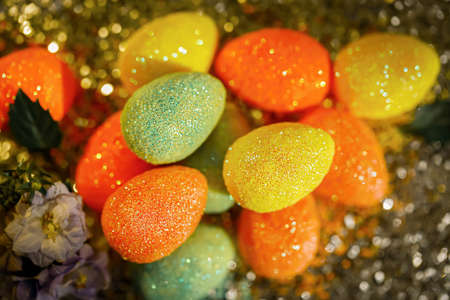 Top view of blurred dark background with Easter eggs and bokeh on a shiny surface.The artistic intend and the filters. Film styleの写真素材