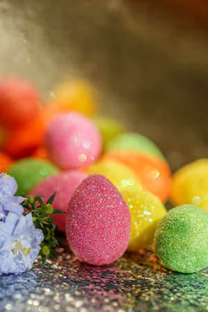 Blurred background with bokeh and Easter eggs. Purple flowers. Close-up.The artistic intend and the filters. Film style.の写真素材