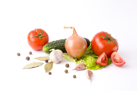 Red peppers and yellow peppers with tomatoes on a white background. Fresh vegetables on a white background. Composition from vegetables. Red and yellow peppers on white background with garlic. Tomato with peppers and cucumber on a white background.の写真素材