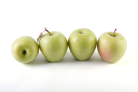 Fresh green apples on a white background. Three green apples on a white background.の写真素材