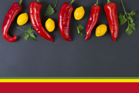 Red and yellow peppers on a black background. Dietary food. Vegetables on a black background. Peppers on the table.の写真素材