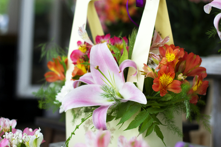 Beautiful pink lilies in a gift box. Bouquet of flowers with lilies.の写真素材
