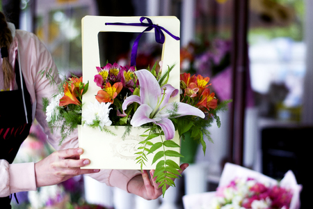 Beautiful pink lilies in a gift box. Bouquet of flowers with lilies.の写真素材