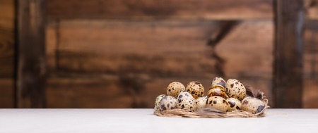 tiny quail eggs on a rustic wood tableの写真素材