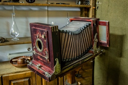 Wooden classic retro camera on tripod on white backgroundの写真素材