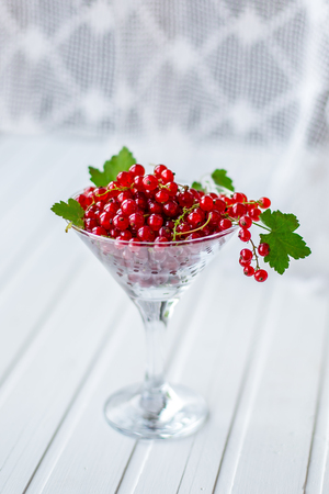 Red currants and berries, on a white table. Organic fruitsの写真素材