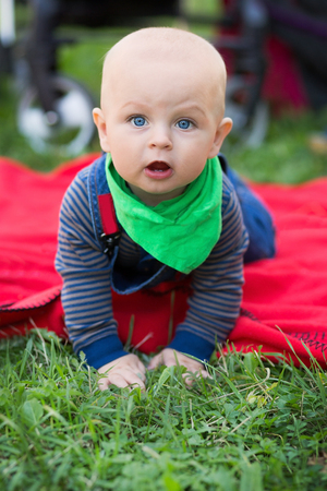 A small child bites a large green apple .の写真素材