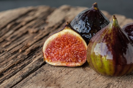A few ripe figs on an old wooden background. Seasonal fruits.の写真素材