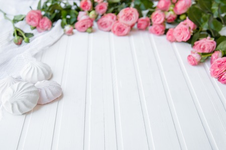 Composition with beautiful pink roses and leaves on a bright table. Place for text.の写真素材