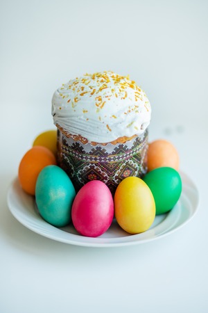 Easter cake with painted eggs on the table.の写真素材