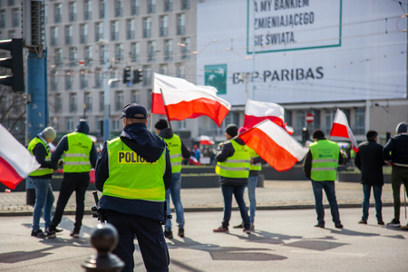 Warsaw Poland. April 3, 2018. Rally of protesters in Warsaw. Protesters holding posters and flags of Poland. On the perimeter are the police.のeditorial素材